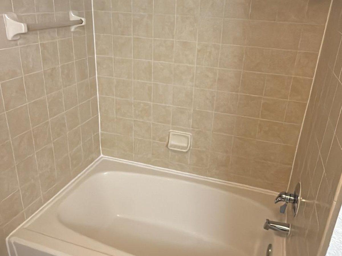 Completed tub surround finished in beige tile