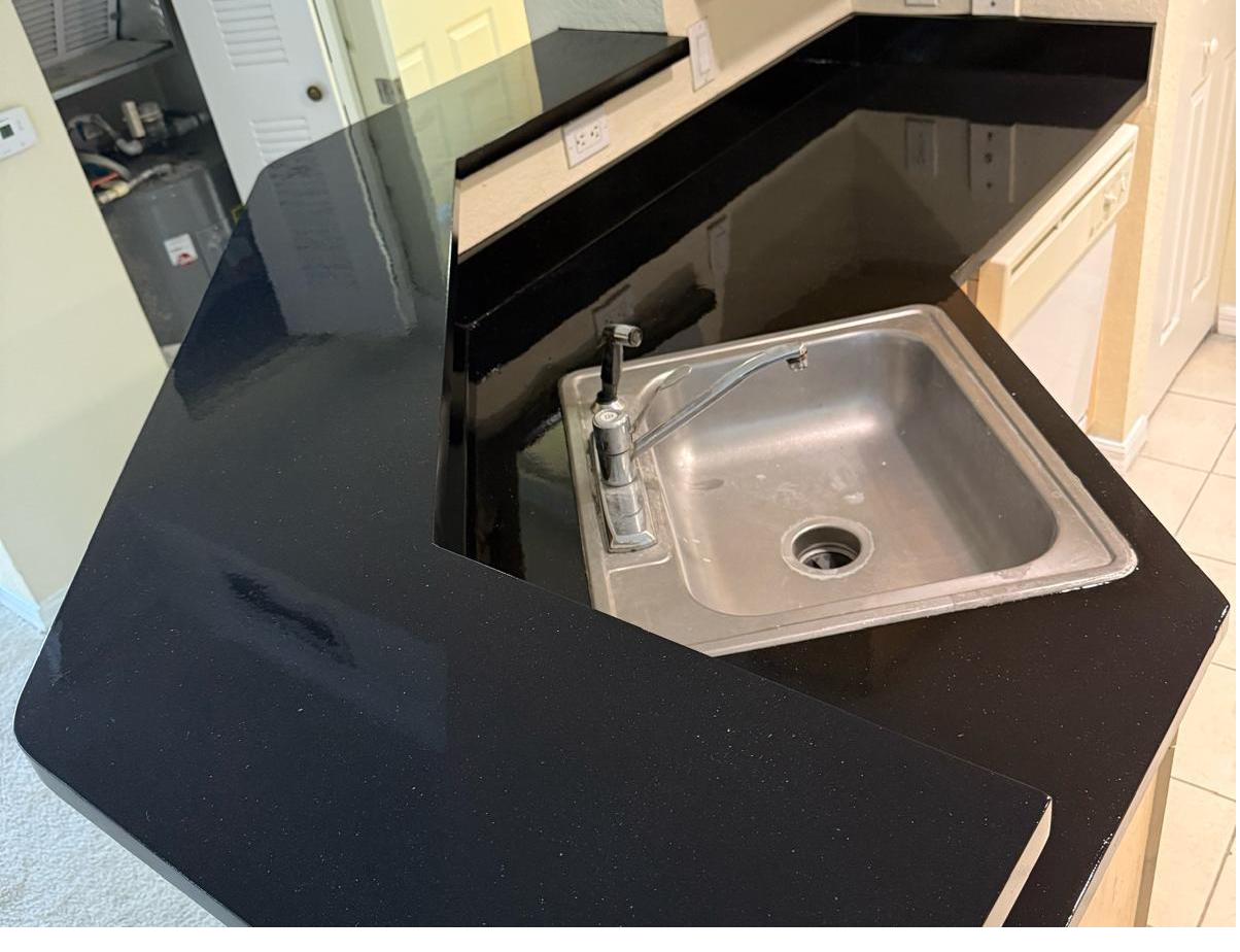 Countertop resurfaced to a deep glossy black finish