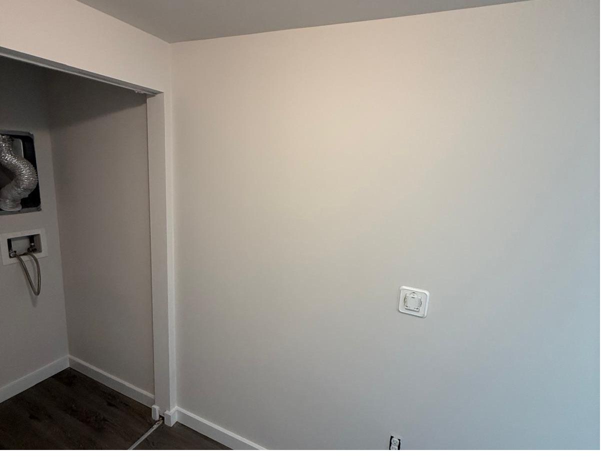 Same wall patched, painted and finished with new flooring